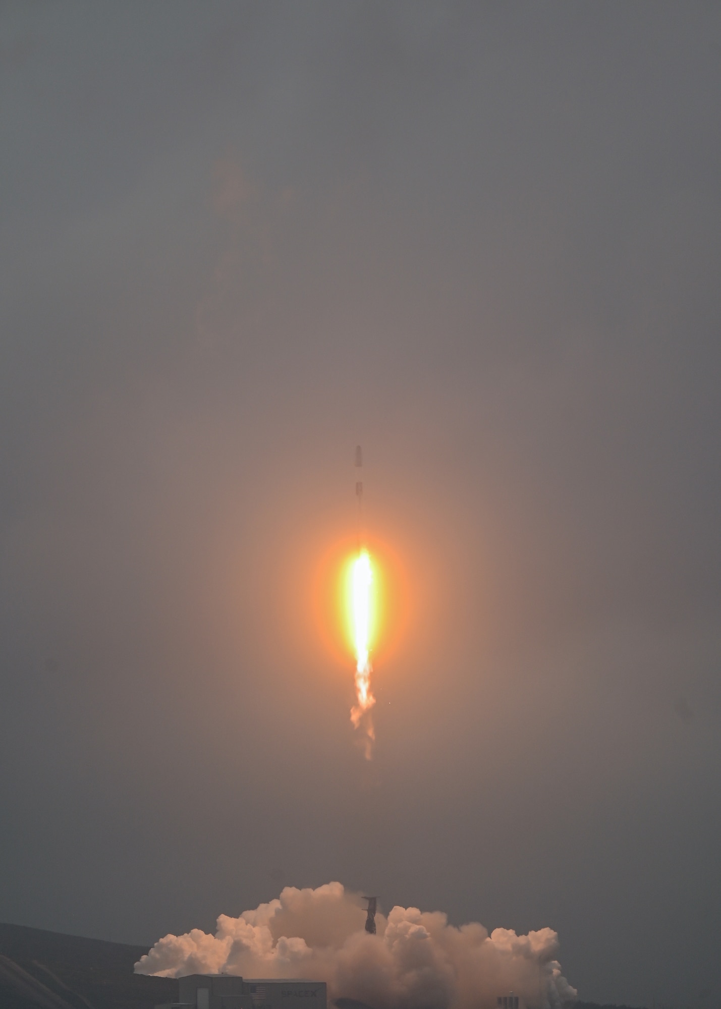 A rocket lifts off of a launch pad.