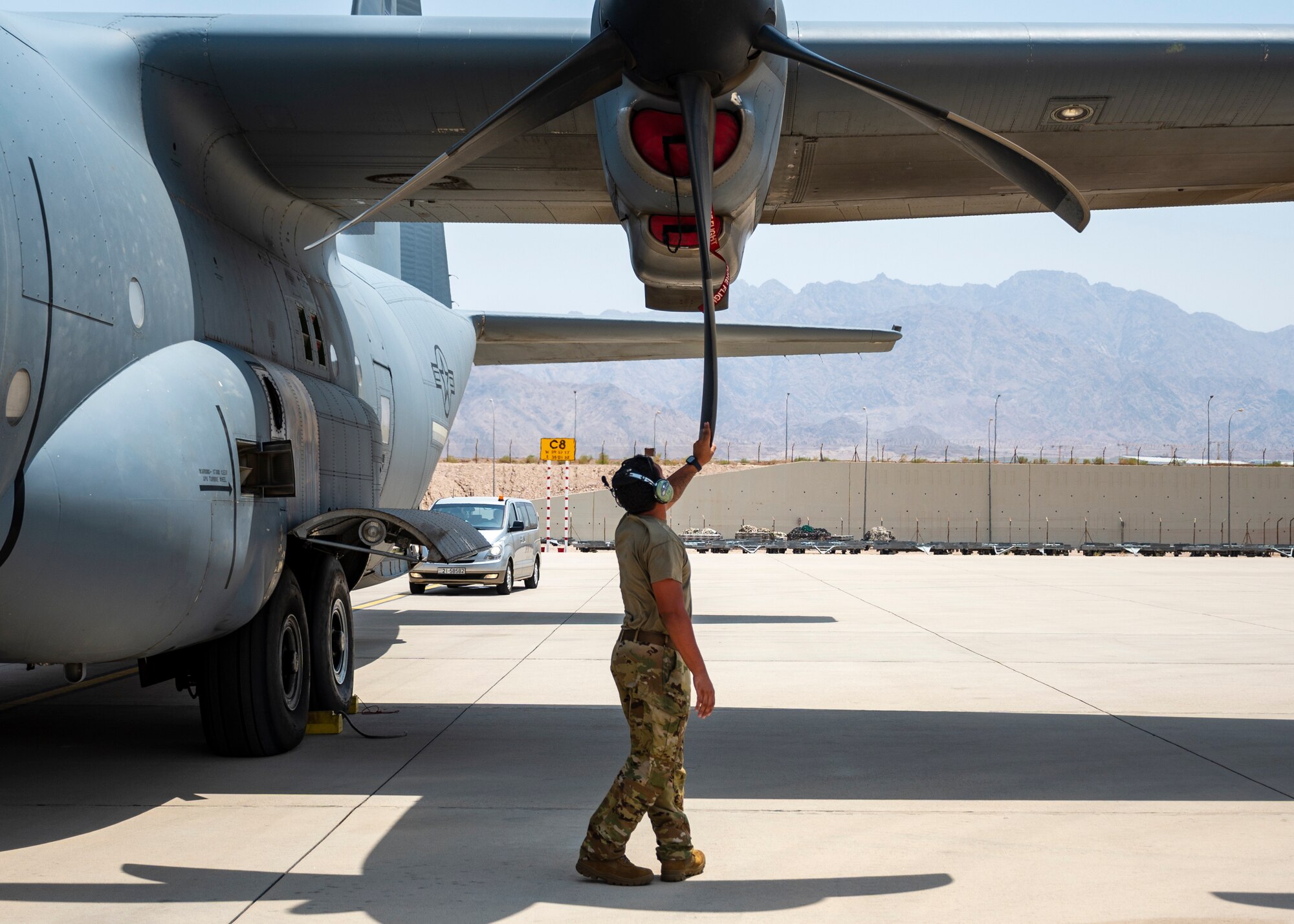 U.S. Air Force Staff Sgt. Malik Wilkins, Flying Crew Chief, 386th Expeditionary Aircraft Maintenance Squadron, conducts a pre-flight inspections and checks on a C-130J aircraft at a remote location as part of Operation Agile Spartan.