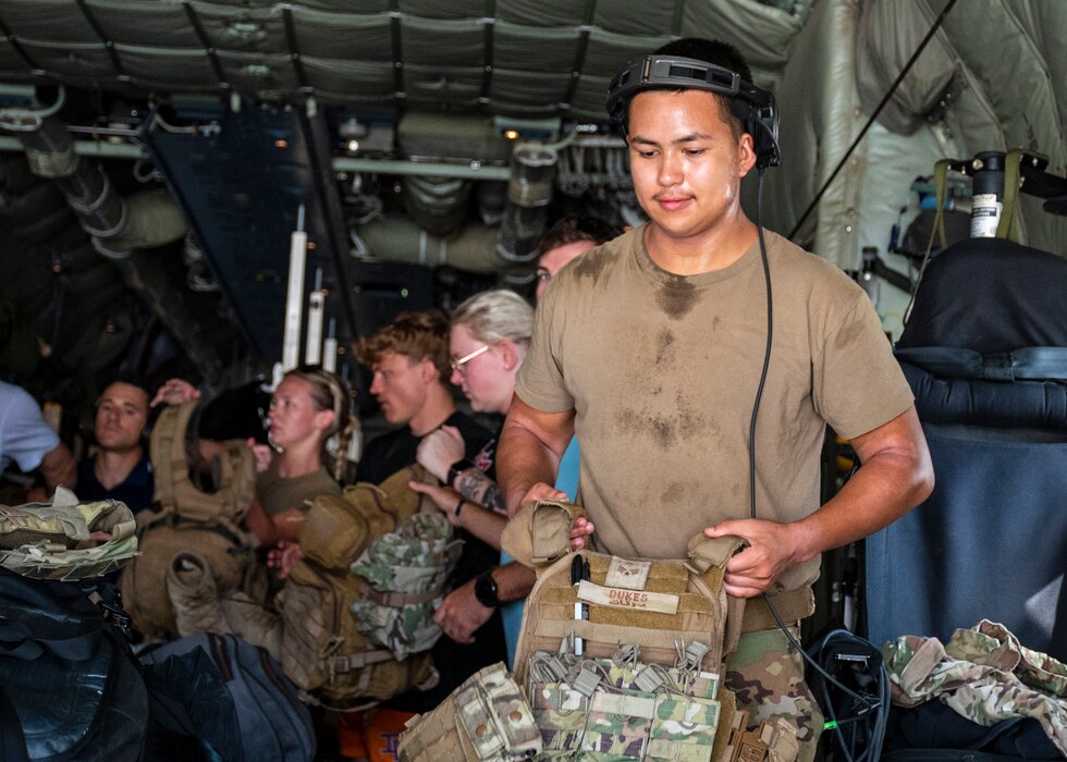 U.S. Air Force Senior Airman Adam Tristam, Instructor Loadmaster, 40th Expeditionary Airlift Squadron, download personnel, cargo and equipment upon departure from a remote location, as part of Operation Agile Spartan.