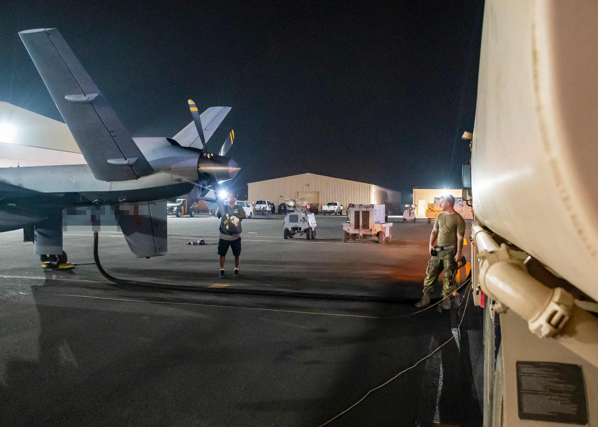 A U.S. Air Force MQ-9 aircraft assigned to the 46th Expeditionary Attack Squadron, receives fuel in preparation for an Operation Agile Spartan mission departing from Ali Al Salem Air Base, Kuwait, August 21, 2023.