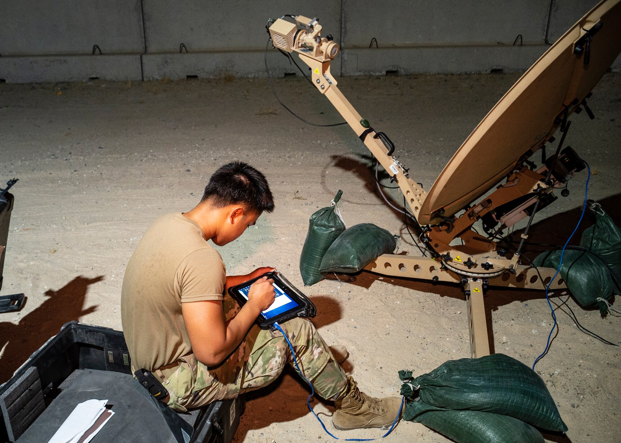 A U.S. Air Force service member assigned to the 386th Expeditionary Communications Squadron assembles and configures a satellite as part of Operation Agile Spartan at Ali Al Salem Air Base, Kuwait, August 21, 2023.