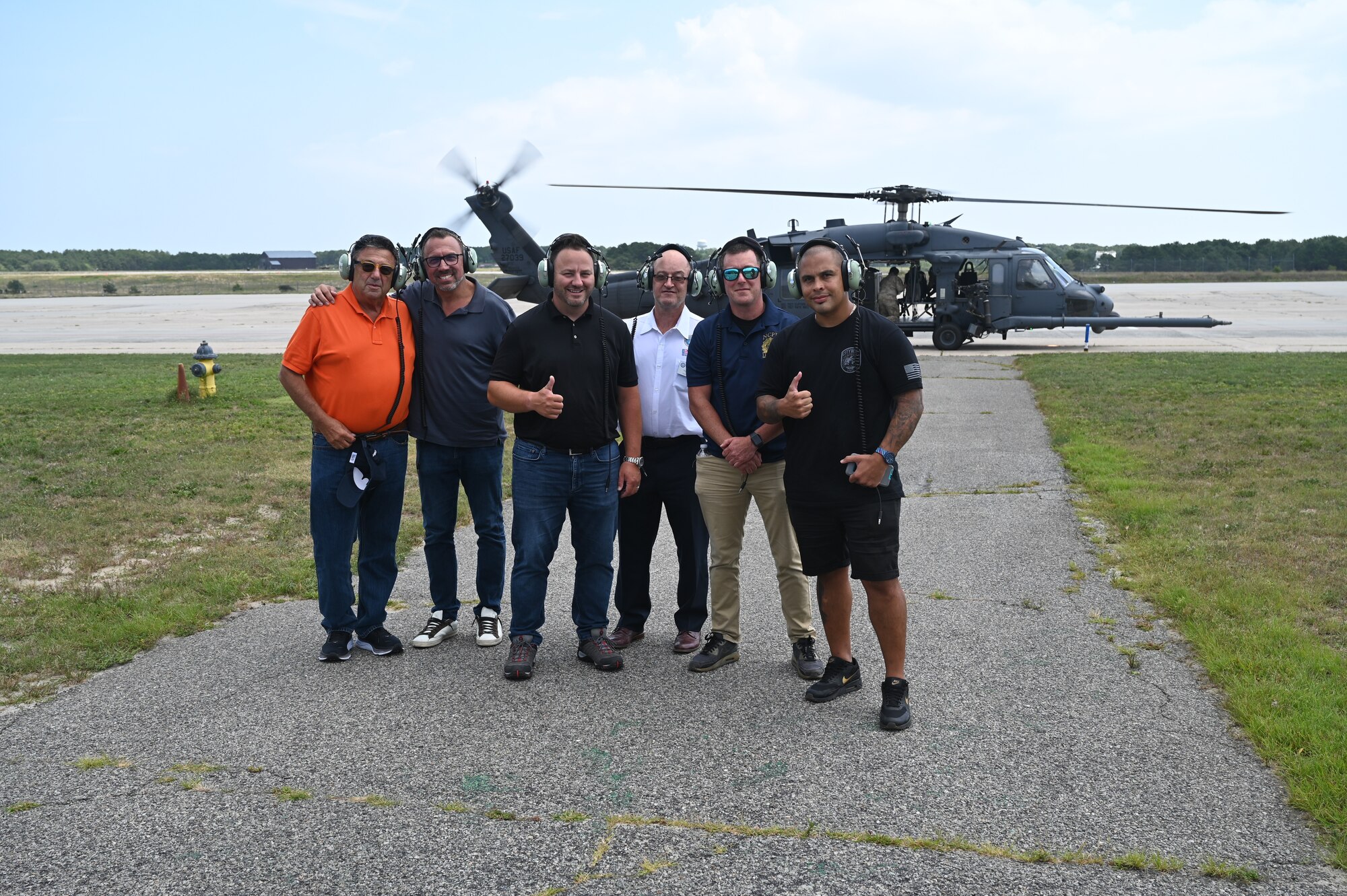 A group of civilian employers of Guardsmen pose for a photo after a flight in an HH-60G Pave Hawk helicopter at the 106th Rescue Wing, Westhampton Beach, N.Y., August 5, 2023. The 106th Rescue Wing welcomed Guardsmen’s civilian employers on base as part of “Bosslift”, an event sponsored by the Employee Support of the Guard and Reserve (ESGR) that allows Guardsmen’s civilian employers to tour the base and fly on an HH-60G Pave Hawk helicopter or HC-130J Combat King II search and rescue aircraft. (U.S. Air National Guard photo by SSgt Daniel H. Farrell)