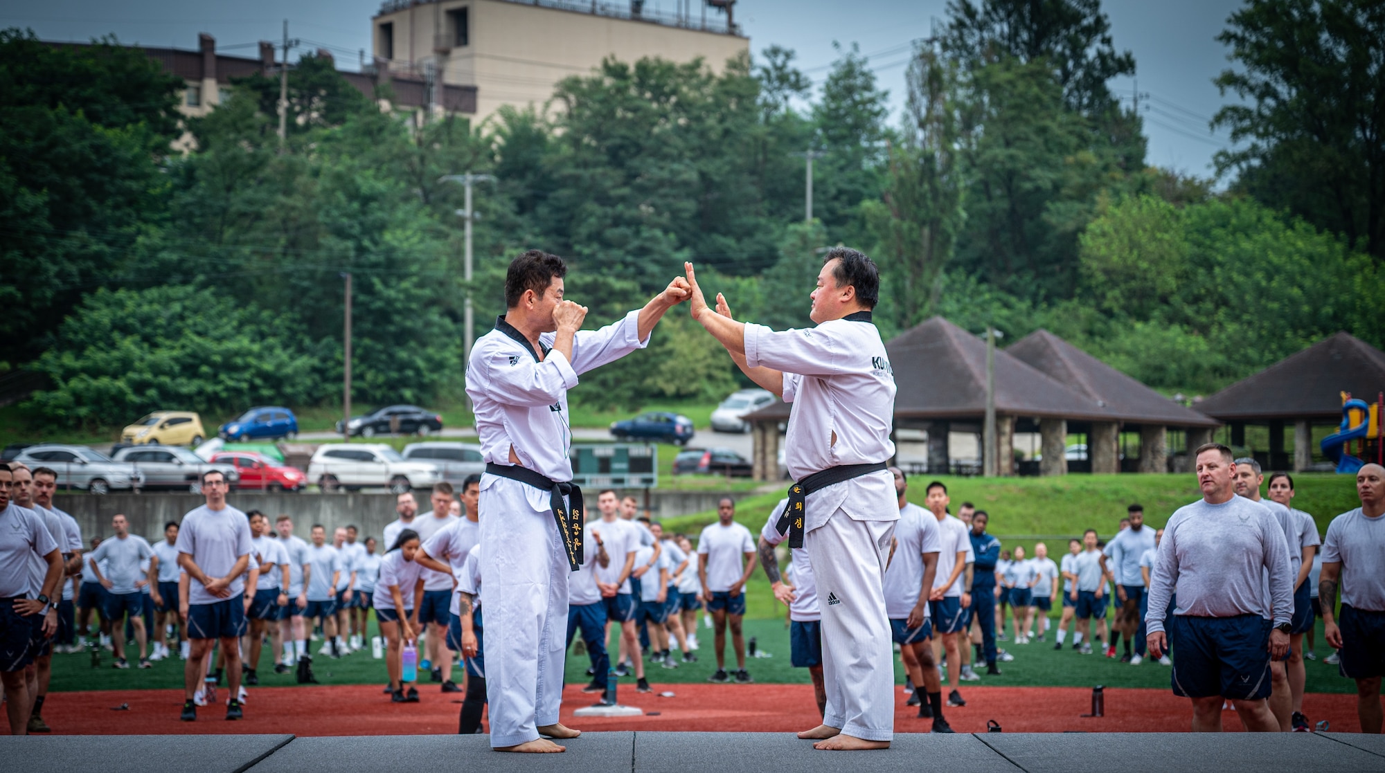 Master Mun He Sung and Master Kim Mun Ok , taekwondo instructors, demonstrate self-defense techniques for the 51st Mission Support Group at Osan Air Base, Republic of Korea, Aug. 25, 2023. Physical fitness aids mission-ready war fighters to be agile, resilient, lethal, and revolutionary. (U.S. Air Force photo by Staff Sgt. Kelsea Caballero)