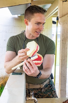 U.S. Navy Lt. Cody Kramer, a native of Lake Havasu City, Arizona and a general dentist with Task Force Koa Moana 23, shows kindergarteners how to properly brush their teeth at Koror Elementary School in Koror, Palau, Aug. 24, 2023. Task Force Koa Moana 23, composed of U.S. Marines and Sailors from I Marine Expeditionary Force, deployed to the Indo-Pacific to strengthen relationships with Pacific Island partners through bilateral and multilateral security cooperation and community engagements. (U.S. Marine Corps photo by Staff Sgt. Courtney G. White)