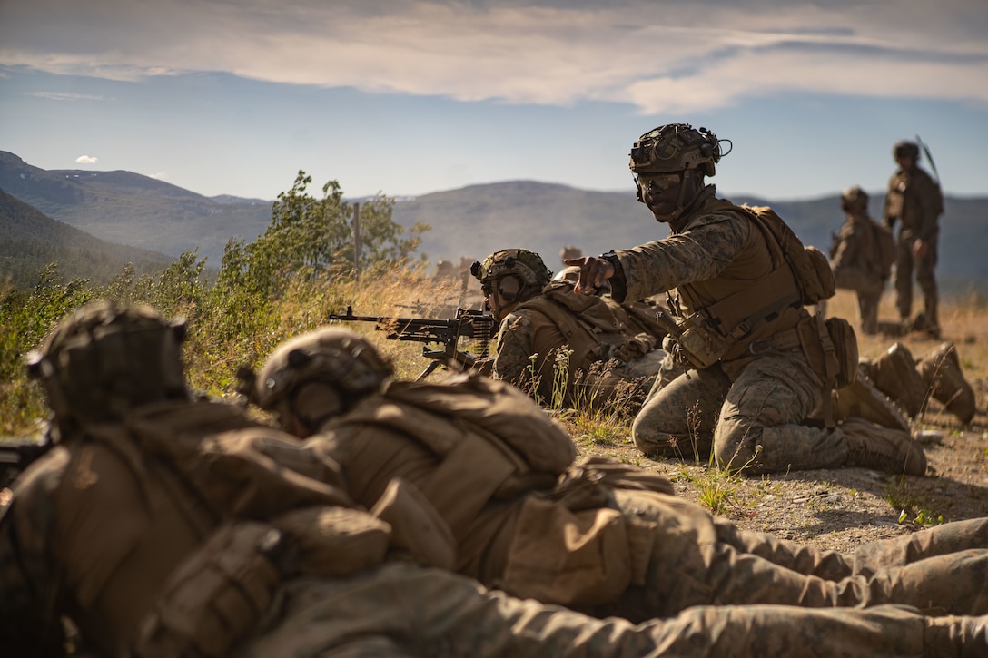 U.S. Marine Sgt. Keegan Green, machine gunner with the Battalion Landing Team 1/6, 26th Marine Expeditionary Unit (Special Operations Capable) (MEU(SOC)) Bravo Command Element, relays information to his Marines during a live-fire range as part of a Norwegian Bilateral Exercise in Setermoen, Norway, Aug. 9, 2023. The San Antonio-class amphibious transport dock ship USS Mesa Verde (LPD 19), assigned to the Bataan Amphibious Ready Group and embarked 26th MEU(SOC), under the command and control of Task Force 61/2, is on a scheduled deployment in the U.S. Naval Forces Europe area of operations, employed by U.S. Sixth Fleet to defend U.S., allied and partner interests. (U.S. Marine Corps photo by Cpl. Michele Clarke)