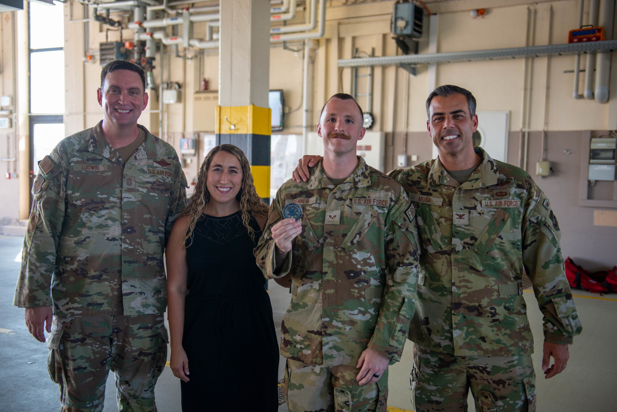 Senior Airman Collin Renner stands with his wife and 86th Airlift Wing leadership after being named Airlifter of the Week