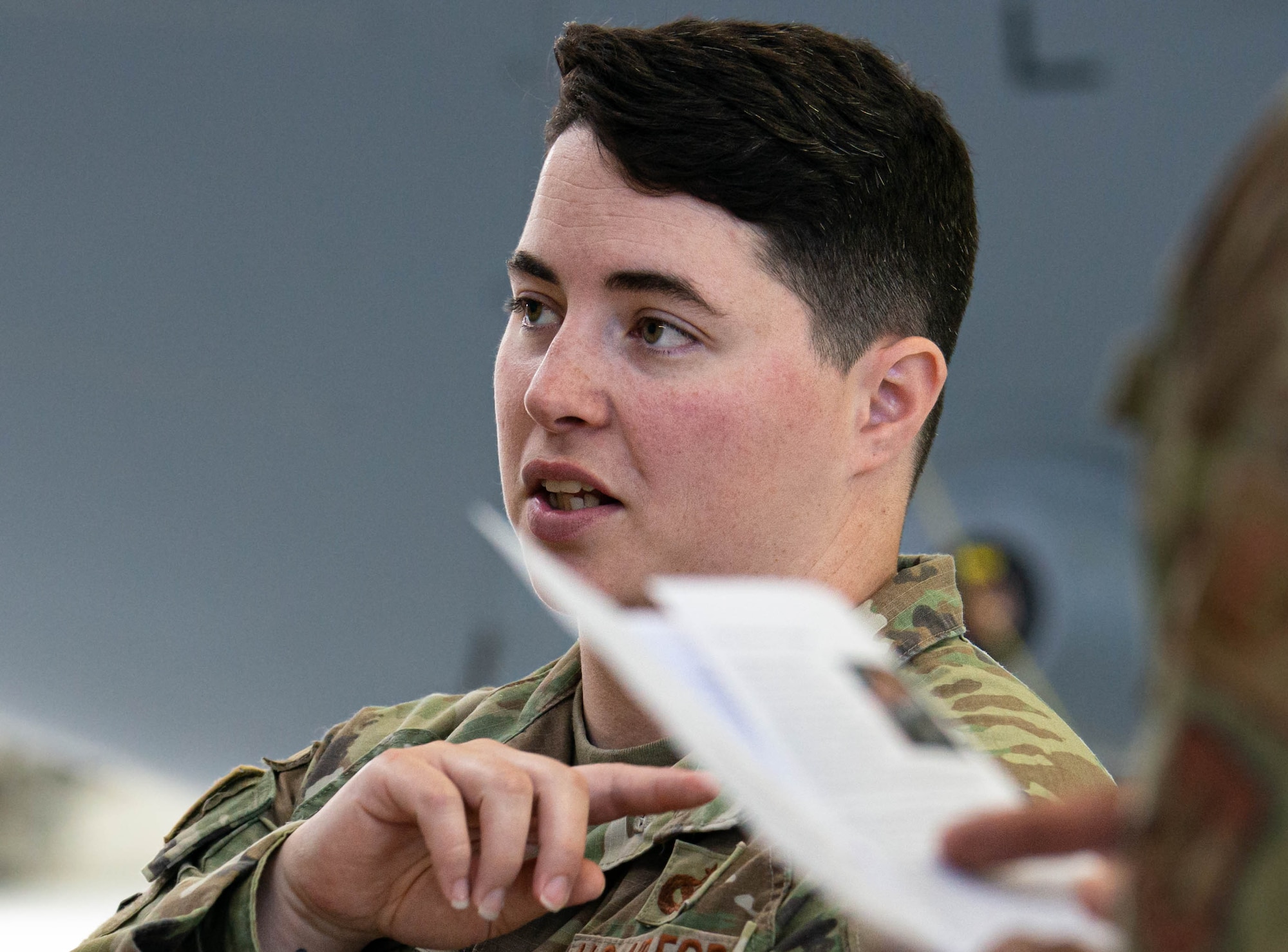 Tech. Sgt. Savanna Hudnall instructs Airmen on proper procedures during a change of command ceremony practice