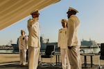 NAVAL STATION ROTA, Spain (August 24, 2023) Capt. Ed Sundberg, Commodore, Destroyer Squadron (DESRON) 60, presides over a change of command ceremony where Cmdr. Tyrchra Bowman (right) relieves Cmdr. Peter Flynn (left) as commanding officer of USS Arleigh Burke (DDG 51), homeported at Naval Station (NAVSTA) Rota, Spain August 24, 2023. As the "Gateway to the Mediterranean,” NAVSTA Rota provides U.S, NATO and allied forces a strategic hub for operations in Europe, Africa and the Middle East. NAVSTA Rota is a force multiplier capable of promptly deploying and supporting combat-ready forces through land, air and sea, enabling warfighters and their families, sustaining the fleet and fostering the U.S. and Spanish partnership. (U.S. Navy photo by LTJG Benjamin K. Cusimano)