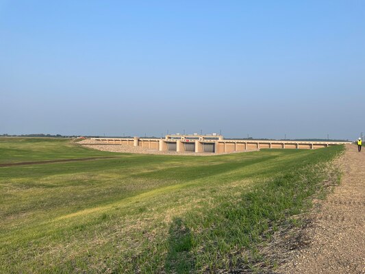 An inlet structure with three gates seen from around 100 feet.