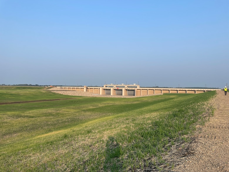 An inlet structure with three gates seen from around 100 feet.