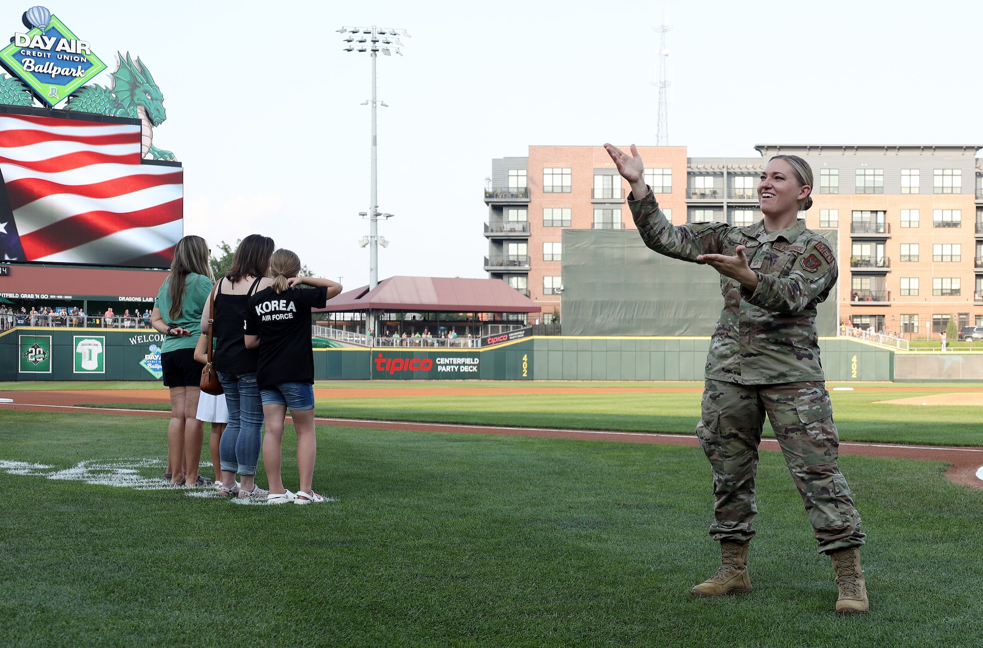 U.S. Air Force Master Sgt. Michelle Lee, 445th Aeromedical Staging Squadron newcomers noncommissioned officer in charge and reservist, signs the national anthem in American Sign Language before a Dayton Dragons baseball game, as the Hometown Hero family is also recognized, at Day Air Ballpark in Dayton, Ohio, Aug. 4, 2023. Lee has provided ASL anthem interpretations at games, musicals and more for several years. (U.S. Air Force photo by Amanda Dick) (No implied endorsement)