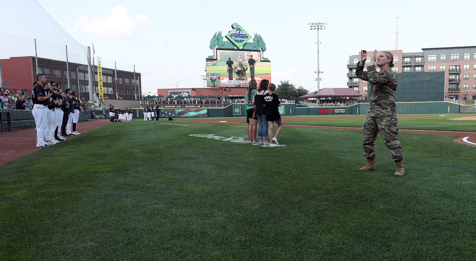 U.S. Air Force Master Sgt. Michelle Lee, 445th Aeromedical Staging Squadron newcomers noncommissioned officer in charge and reservist, signs the national anthem in American Sign Language before a Dayton Dragons baseball game at Day Air Ballpark in Dayton, Ohio, Aug. 4, 2023. Lee has provided ASL anthem interpretations at games, musicals and more for several years. (U.S. Air Force photo by Amanda Dick) (No implied endorsement)
