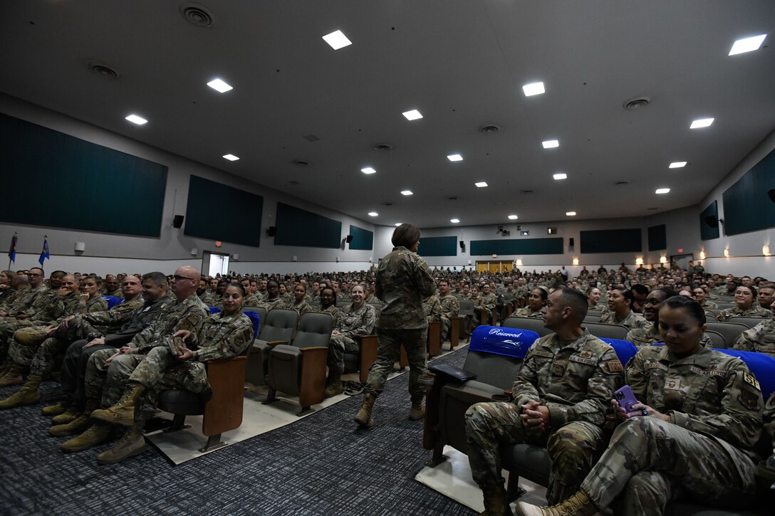 Military members meet in the base theater.