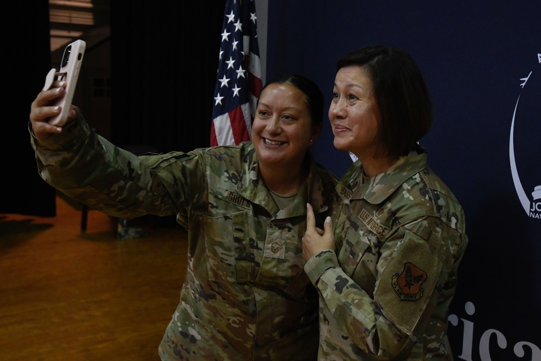 Two women in uniform take a selfie together.