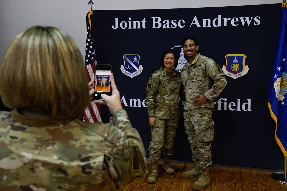 A man and a woman in uniform pose for a photo.