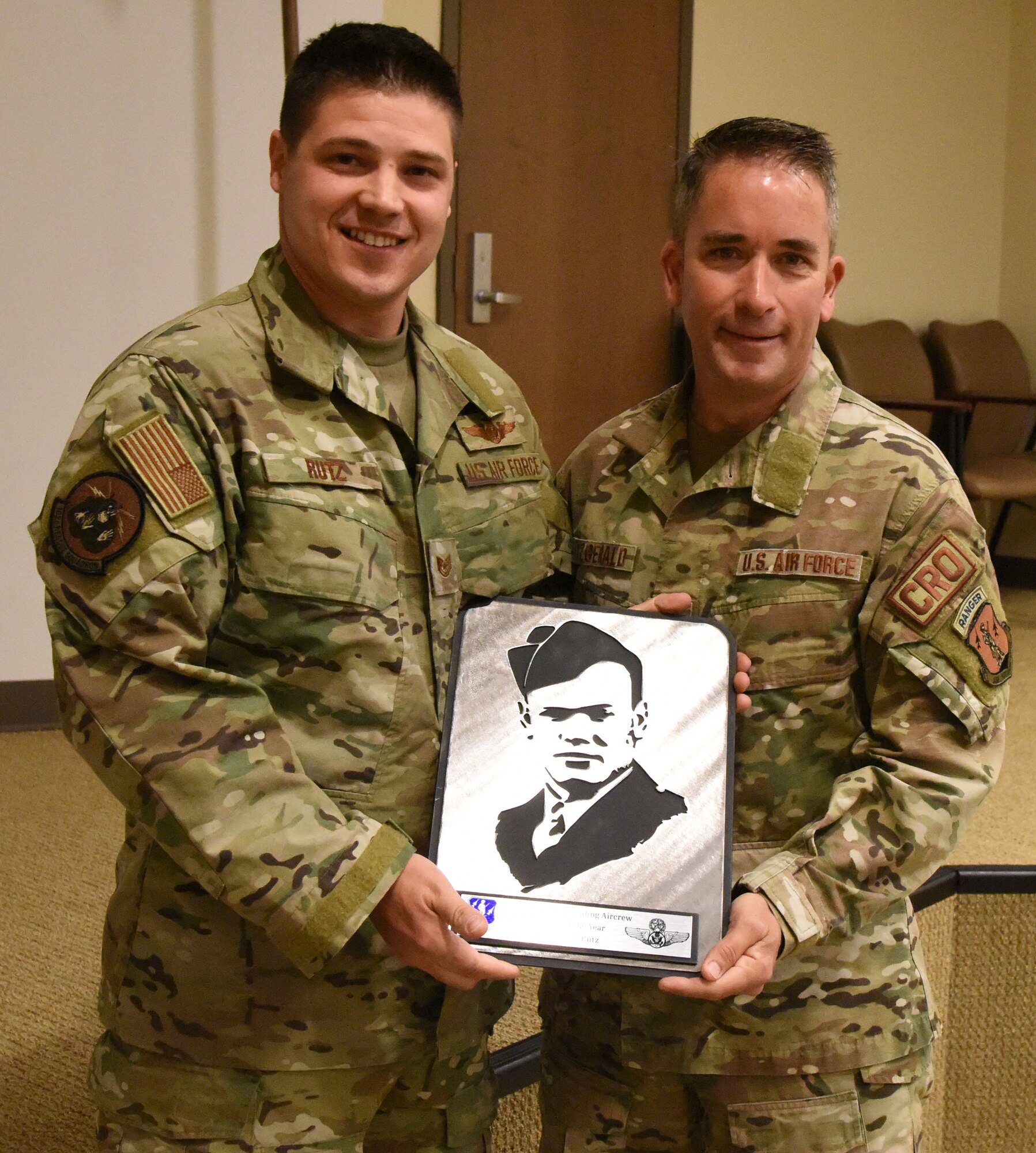 Left, Tech Sgt.  Ryan Rutz a loadmaster assigned to the N.Y. Air National Guard, 106th Rescue Wing stands with Col. Shawn Fitzgerald 106 RQW Wing Commander at F.S. Gabreski Air National Guard Based, May 6, 2023. Rutz recieved the Air National Guard 2022 Henry "Red" Erwin Outstanding NCO Aircrew Member of the Year Award, which recognizes excellence in the enlisted aircrew career field. (U.S. Air National Guard photo by Staff Sgt. Sean Madden)