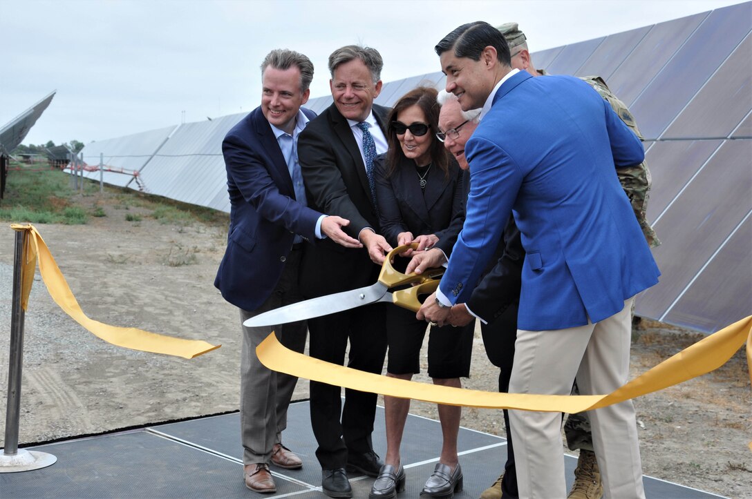 A ribbon is cut to open the new solar power project at Joint Forces Training Base Los Alamitos, Aug. 11, at Los Alamitos, Calif.