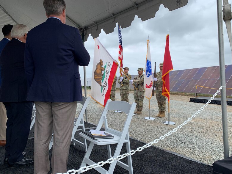 Attendees salute the flag during the singing of the National Anthem at a ribbon cutting ceremony for the JTFB Los Alamitos Energy Resilience Project Aug. 11 at Los Alamitos, Calif.