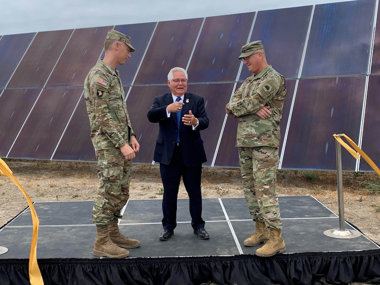U.S. Army Corps of Engineers Los Angeles District commander Col. Andrew Baker, California 30th District state senator Bob Archuleta, and Maj. Gen. Matthew Beevers stand before 100 acres of solar panels during the Joint Forces Training Base Los Alamitos Energy Resilience Project ribbon cutting ceremony, Aug. 11, at Los Alamitos, Calif.