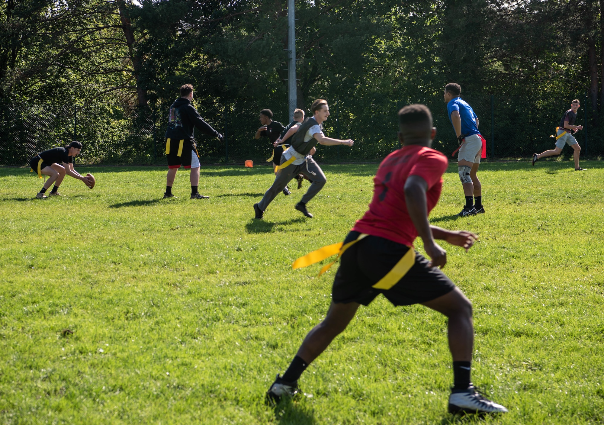 Participants play flag football.