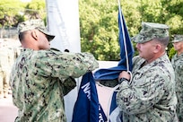 230901-N-PI330-1114 ROTA, Spain (September 1, 2023) Command Master Chief Duane Jerry, left, assigned to Naval Mobile Construction Battalion 133 (NMCB 133), and Command Master Chief Erwin Hoffman, assigned to Naval Mobile Construction Battalion 1 (NMCB 1), change command flags during a turnover ceremony for Camp Mitchell in Rota, Spain, September 1, 2023. NMCB 133 is on a scheduled deployment in the U.S. Naval Forces Europe area of operations, employed by the U.S. Sixth Fleet to defend U.S., allied and partner interests. (U.S. Navy photo by Mass Communication Specialist 2nd Class Andrew Waters)