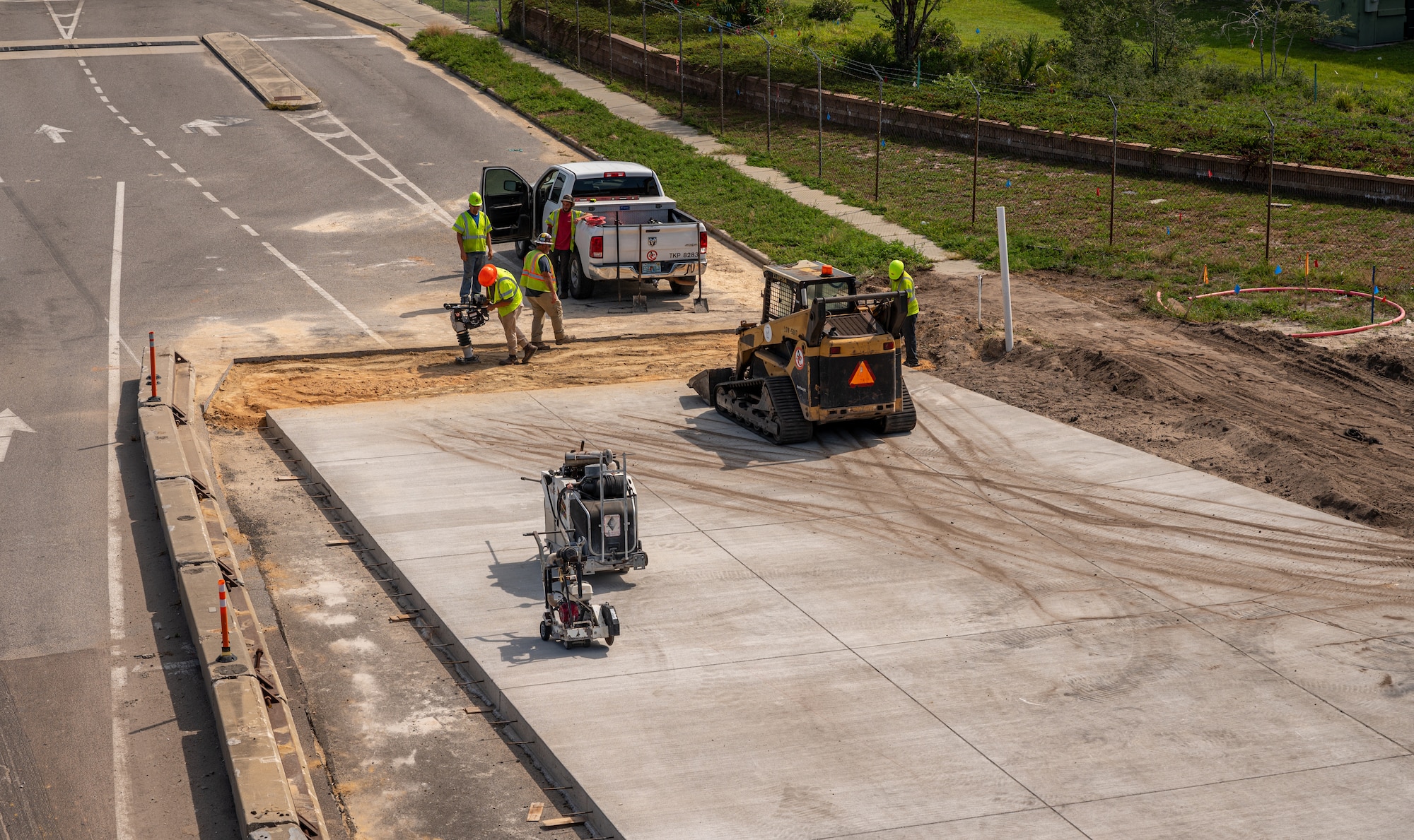 Construction workers operate on concrete slabs