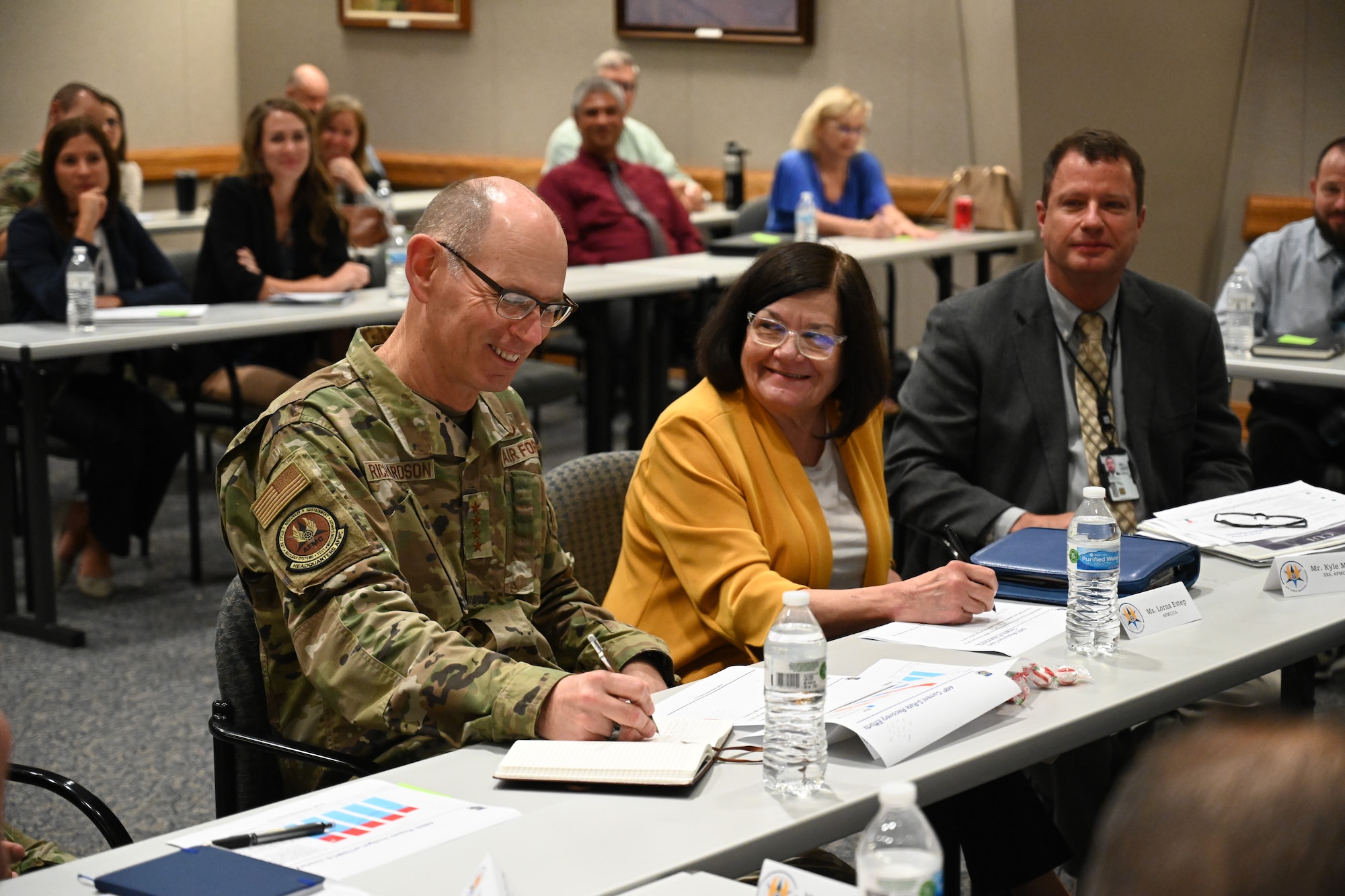 AFMC Commander and other senior leader sitting together for a presentation.