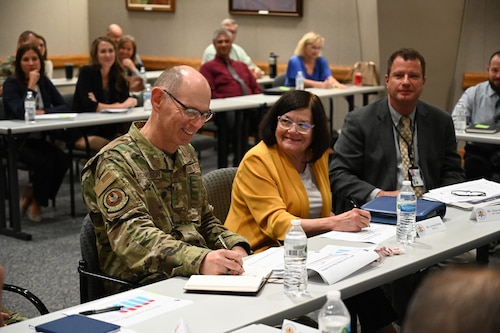 AFMC Commander and other senior leader sitting together for a presentation.