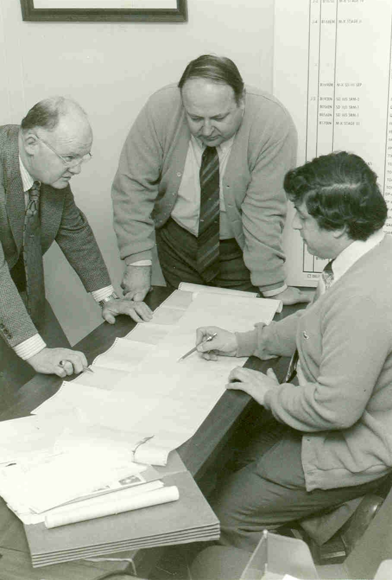 Richard Austin, left, then-deputy director of Propulsion Test at Arnold Engineering Development Center, later known as Arnold Engineering Development Complex, is among AEDC personnel who gathered to examine data collected on Space Shuttle Challenger at Marshall Space Flight Center in Huntsville, Ala., in the early 1980s. AEDC was instrumental in identifying the source of hydrogen leaking from within the Challenger’s main motors. Also pictured are Alex Domal, center, then-acting chief of the AEDC Rocket Division of the Directorate of Propulsion Test, and Vince Zaccardi, research engineer with AEDC’s then-aeropropulsion test contractor. (U.S. Air Force photo by Phil Tarver)