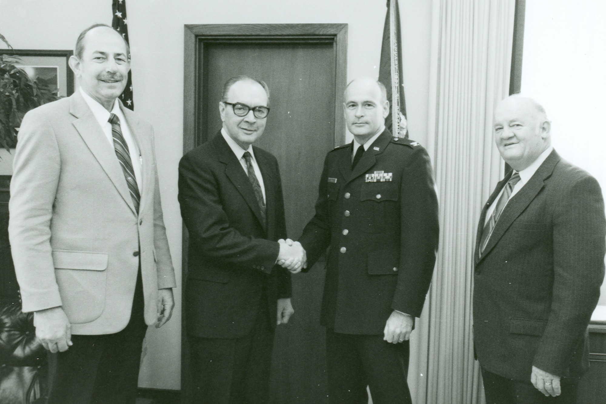 Richard Austin, right, then-deputy director of Arnold Engineering Development Center Propulsion Test, is present for the early 1990s handshake between then-AEDC Commander Col. Richard Roellig, second from right, and Ray Lemaire, manager of Engineering Operations in Commercial Engine Business for Pratt & Whitney. Roellig and Lemaire shook to acknowledge an agreement for AEDC to test Pratt & Whitney’s new PW4084 commercial aircraft engines. Also pictured is Don Craig with Pratt & Whitney. (U.S. Air Force photo)