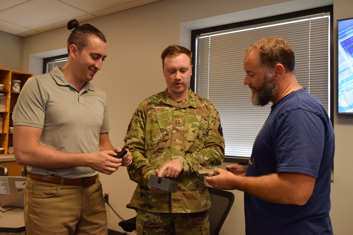 Capt. Connor Egbert, center, Air Force Institute of Technology Civil Engineer School pavement instructor discusses materials properties with students Derek Probstfeld, left, and Jamie Sawyer, right. (US Air Force photo by Katie Scott)