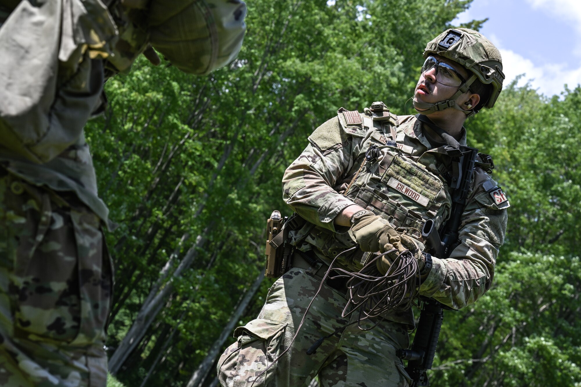 Airman 1st Class Trent Gilwood, a Defender assigned to the 349th Security Forces Squadron, Travis Air Force Base, California, gathers spent wire after claymore detonation on Aug. 15, 2023, at Camp James A. Garfield Joint Military Training Center, Ohio.