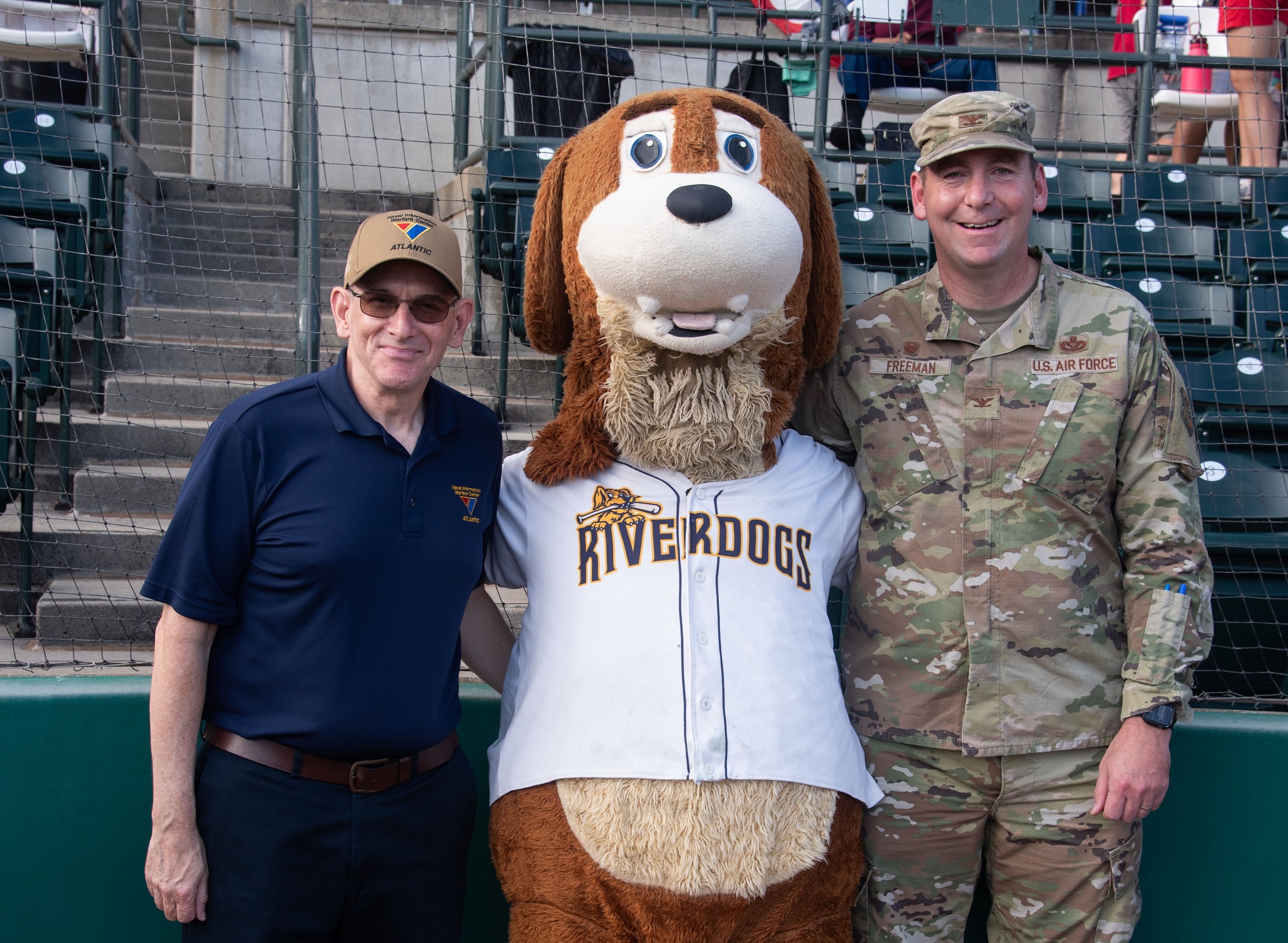 Charleston, SC (September 2, 2023) Naval Information Warfare Center (NIWC) Atlantic Executive Director Peter Reddy and Commander 628th Air Base Wing Joint Base Charleston Colonel Michael Freeman attended the Charleston RiverDogs baseball game to throw out a ceremonial first pitch at the military appreciation game Sept. 2 in Charleston, South Carolina.