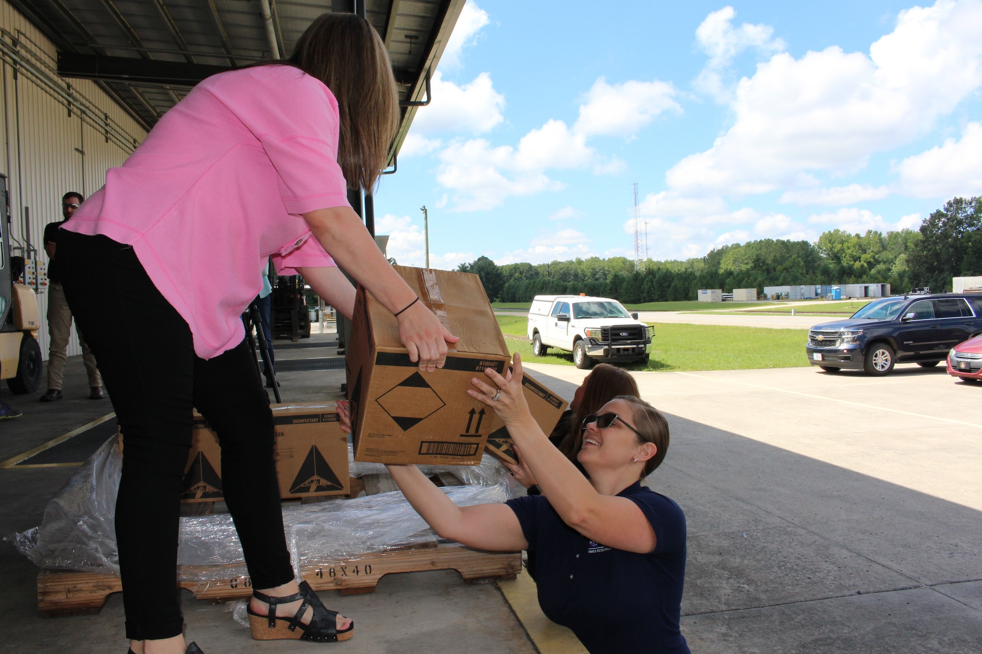 Arnold Engineering Development Complex team members Hayley Douglas, left, and Ashley Clark load boxes of donated cleaning supplies Aug. 16, 2023, at Arnold Air Force Base, Tenn., headquarters of AEDC. While these items are no longer able to be used at AEDC due to expiry dates, they were able to be put to beneficial use by local organizations. (U.S. Air Force photo by Kali Bradford)