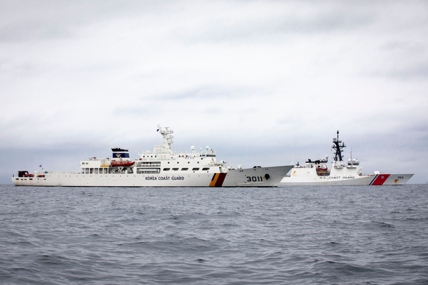 Korea Coast Guard vessel KCG 3011 (Badaro) (foreground) and U.S. Coast Guard Cutter Munro (WMSL 755) conduct an at-sea engagement in the Tsushima Strait Aug. 16, 2023. Munro is deployed to the Indo-Pacific to advance relationships with ally and partner nations to build a more stable, free, open, and resilient region with unrestricted, lawful access to the maritime commons. (U.S. Navy photo by Chief Petty Officer Brett Cote)