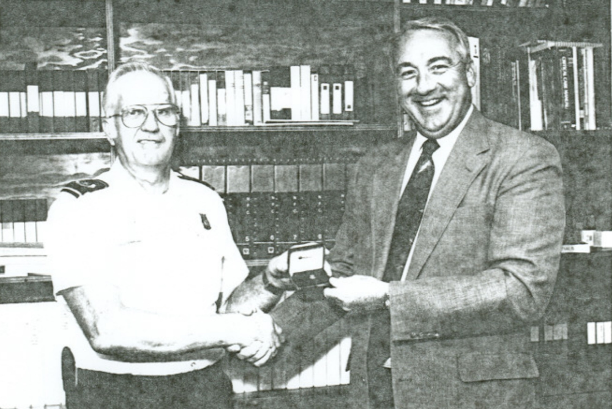 L.C. Gunn receives a pin with a diamond commemorating 40 years of service in 1992 from then SSI Services Inc. Vice President and General Manager J. R. Tully at Arnold Air Force Base, Tenn. (U.S. Air Force Photo)