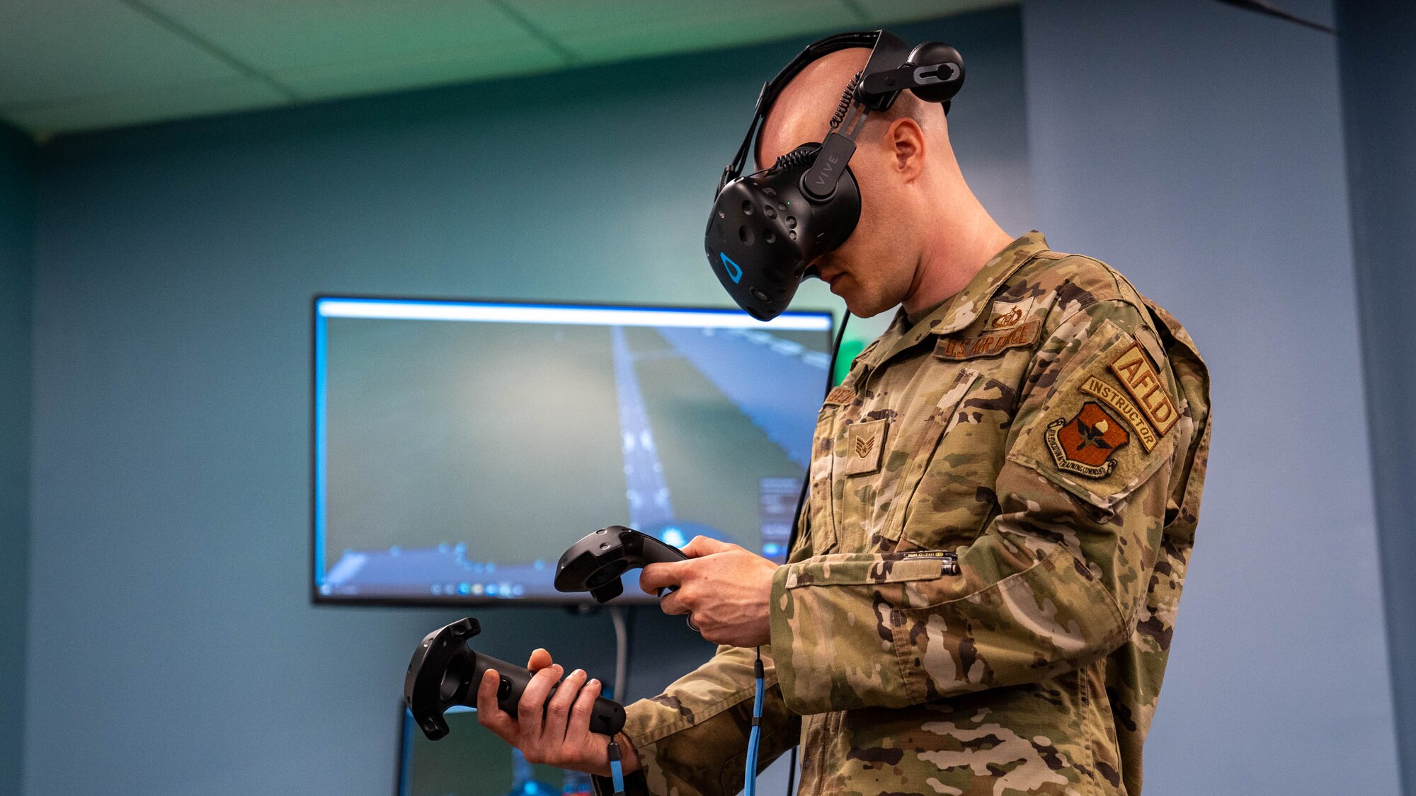 U.S. Air Force Staff Sgt. Joel Gearo, 334th Training Squadron airfield management instructor, demonstrates how simulators are used for Meridian High School JROTC students at the 334th TRS at Keesler Air Force Base, Mississippi, Aug. 22, 2023.