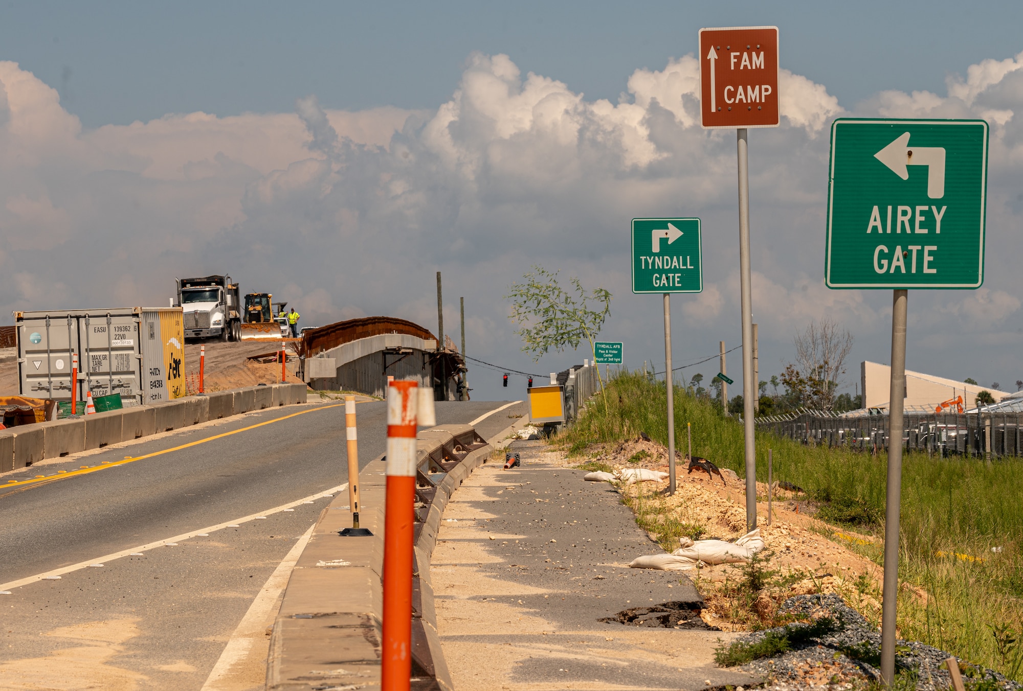 Street signs stand aside a construction site