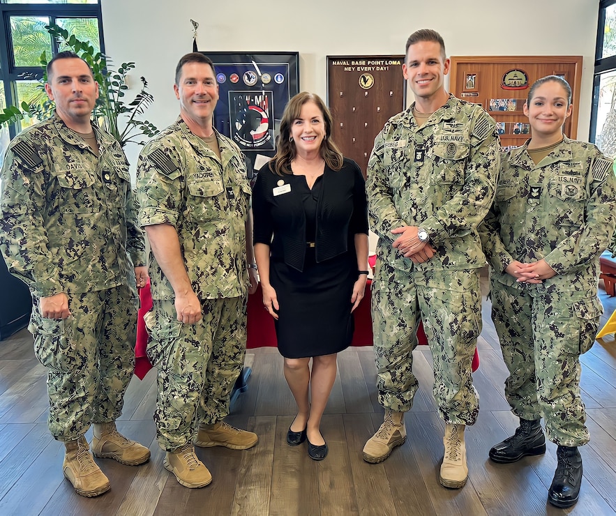 Tracy Owens (center), Programs Manager of Support the Enlisted Project (STEP), a non profit organization dedicated to helping military families in need, poses for a photo with the Naval Base Point Loma Command Triad after STEP was announced as the recipient of the Navy's 2023 Spirit of Hope Award.  The award is presented to individuals or organizations, identified by each service, that embody the core values of Mr. Bob Hope, who gave generously to military men and women for five decades as a comedian and entertainer. Mr. Hope’s values of Duty, Honor, Courage, Loyalty, Commitment, Integrity, and Selfless Dedication exemplify the character traits Service members embody each and every day. (U.S. Navy photo by Sharon StephensonPino/Released)