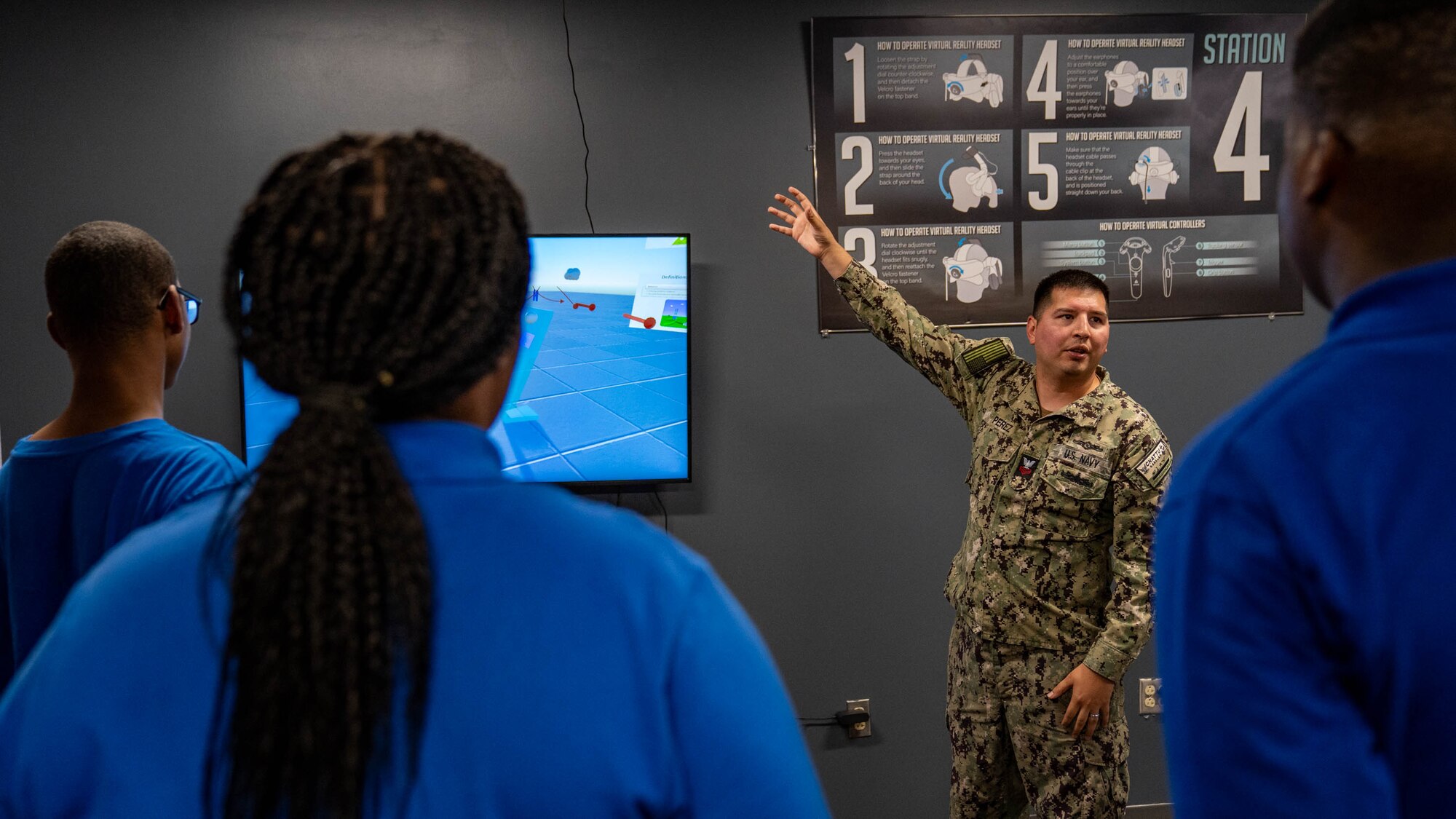 U.S. Navy Aerographer’s Mate 1st Class Xenon Perez, 335th Training Squadron instructor, discusses weather patterns with Meridian High School JROTC students at the 335th TRS at Keesler Air Force Base, Mississippi, Aug. 22, 2023.
