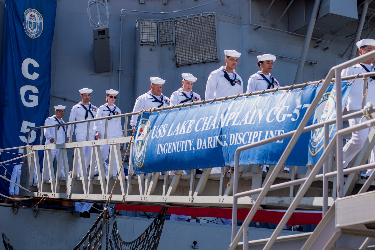 The crew of USS Lake Champlain (CG 57) disembark the ship during a decommissioning ceremony at Naval Base San Diego.