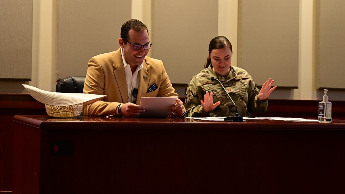 U.S. Air Force Capt. Emily Jacobs, 17th Training Wing chief of military justice, and Trey Holmes, 17th TRW honorary commander, review documents before a mock trial at Goodfellow Air Force Base, Texas, Aug 30, 2023. A mock trial was held to show a small part of the process that judge advocates go through during a court martial. (U.S. Air Force photo by Airman 1st Class Zach Heimbuch)