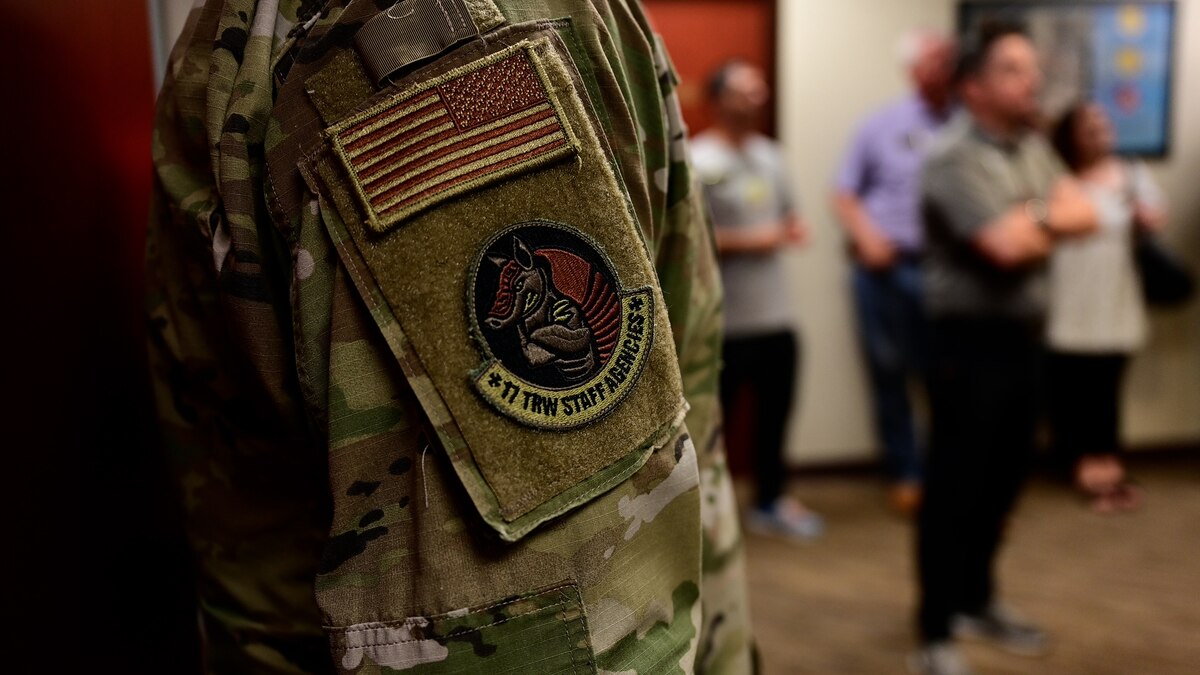 A Wing Staff Agency patch is displayed on an Airman's arm while 17th Training Wing honorary commanders are briefed on the mission of the Comptroller Squadron at Goodfellow Air Force Base, Texas, Aug 30, 2023. This year's class of 17th Training Wing honorary commanders had their last immersion with the Wing Staff Agencies. (U.S. Air Force photo by Airman 1st Class Zach Heimbuch)