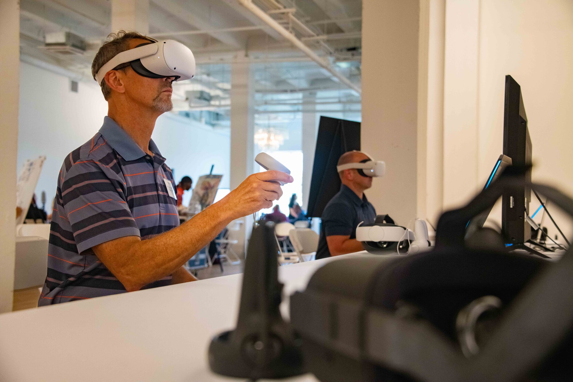 Learning professionals attending the Air Education and Training Command Learning Symposium engage with technology demonstrating artificial intelligence and virtual reality, Aug. 24, 2023. The symposium was held Aug. 22-24 at Air University, Maxwell Air Force Base, Ala., with the last day being held at the Kress building in downtown Montgomery, Ala. The symposium provided the more than 60 attendees a ‘sharing space’ to learn from and hear about each other’s stories and successes, with the goal of transforming the way Airmen and Guardians learn. (U.S. Air Force photos by Sean Ross)