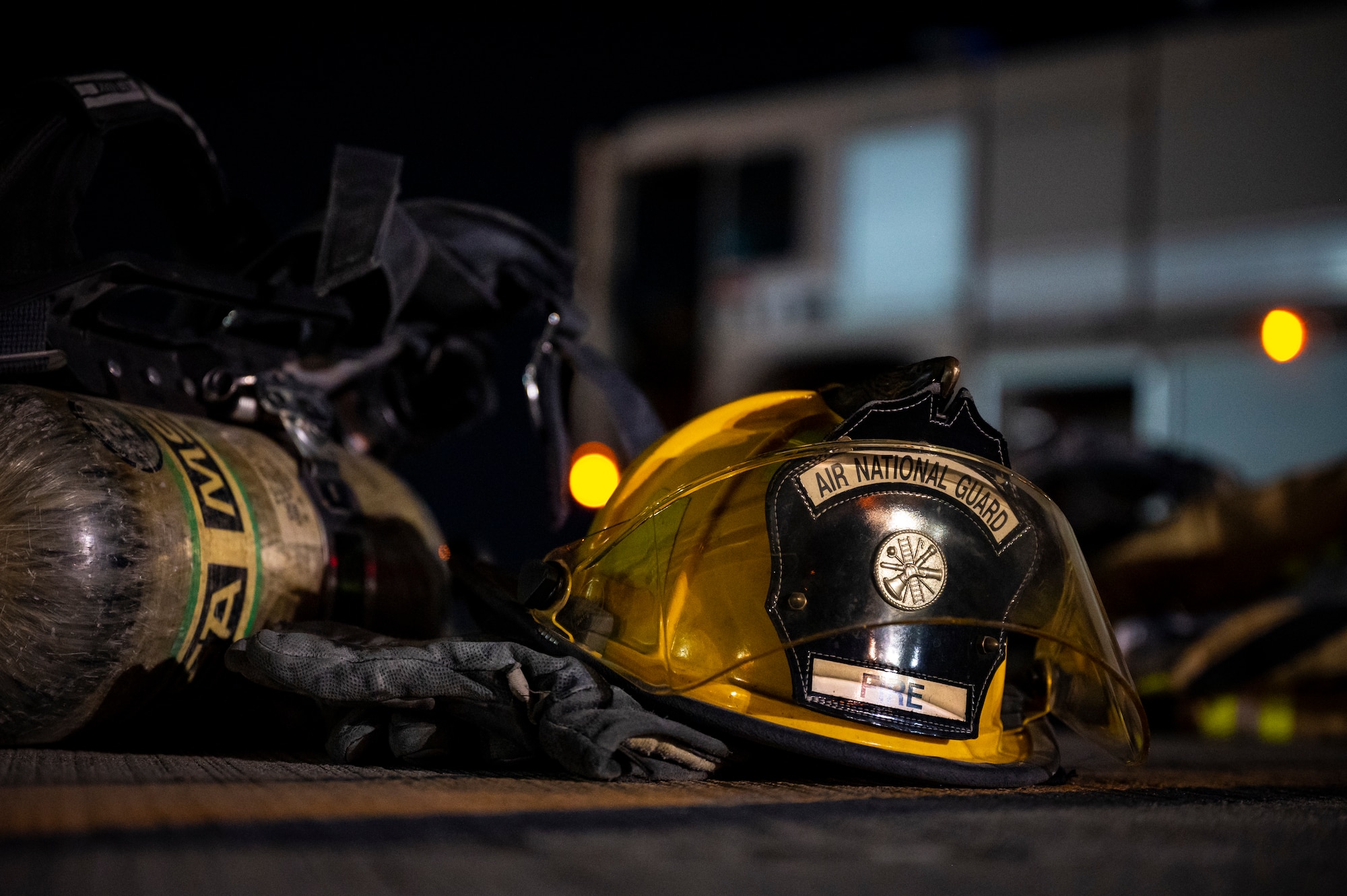 Firefighting gear sits on the ground of the flight line.