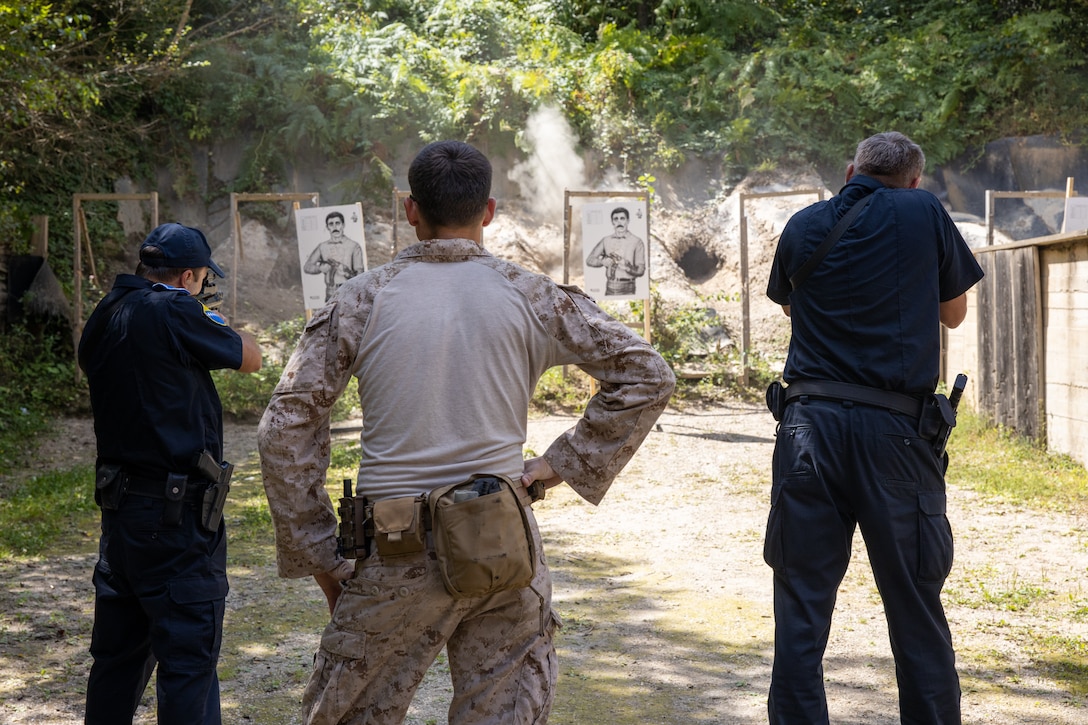 U.S. Marine Corps Lance Cpl. Robert White, infantry machine gunner, native of New Market Alabama, Fleet Anti-Terrorism Security Team Company, Europe (FASTEUR), center, conducts a live fire exercise with Steyr AUG 43s with Bosnian police officers at a shooting range in Sarajevo, Bosnia-Herzegovina, Aug. 28, 2023. Task Force 61/2.3 (FASTEUR), under the tactical command and control of Task Force 61/2, provides capabilities such as rapid response expeditionary anti-terrorism and security operations in support of Commanders, United States European Command (COMESEUCOM) and as directed by Commander, U.S. 6th Fleet (C6F) in order to protect vital naval and national assets. (U.S. Marine Corps photo by LCpl. Jack Labrador)