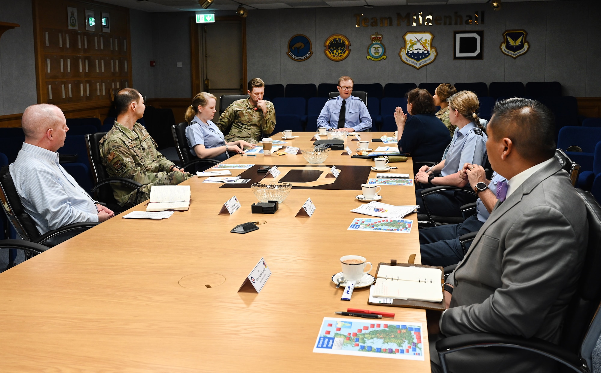 Air Commodore Simon Strasdin, center, Royal Air Force Intelligence, Surveillance, Target Acquisition and Reconnaissance force commander, based at RAF Waddington, meets with base leadership during a visit to RAF Mildenhall, England, Aug. 23, 2023. Strasdin was here to strengthen United Kingdom-US relationships and thank 100th ARW, 95th Reconnaissance Squadron and 488th Intelligence Squdron Airmen for their hard work and cooperation in the joint partnership program between the RAF and U.S. Air Force reconnaissance aircraft. (U.S. Air Force photo by Karen Abeyasekere)