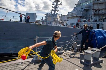 USS Benfold (DDG 65) prepare to throw a heaving ball during a sea and anchor detail in Yokosuka, Japan.