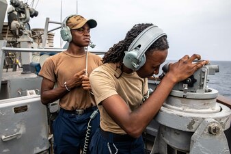 Sailors stand port bearing and lookout watch aboard USS McFaul (DDG 74) in the Gulf of Oman.