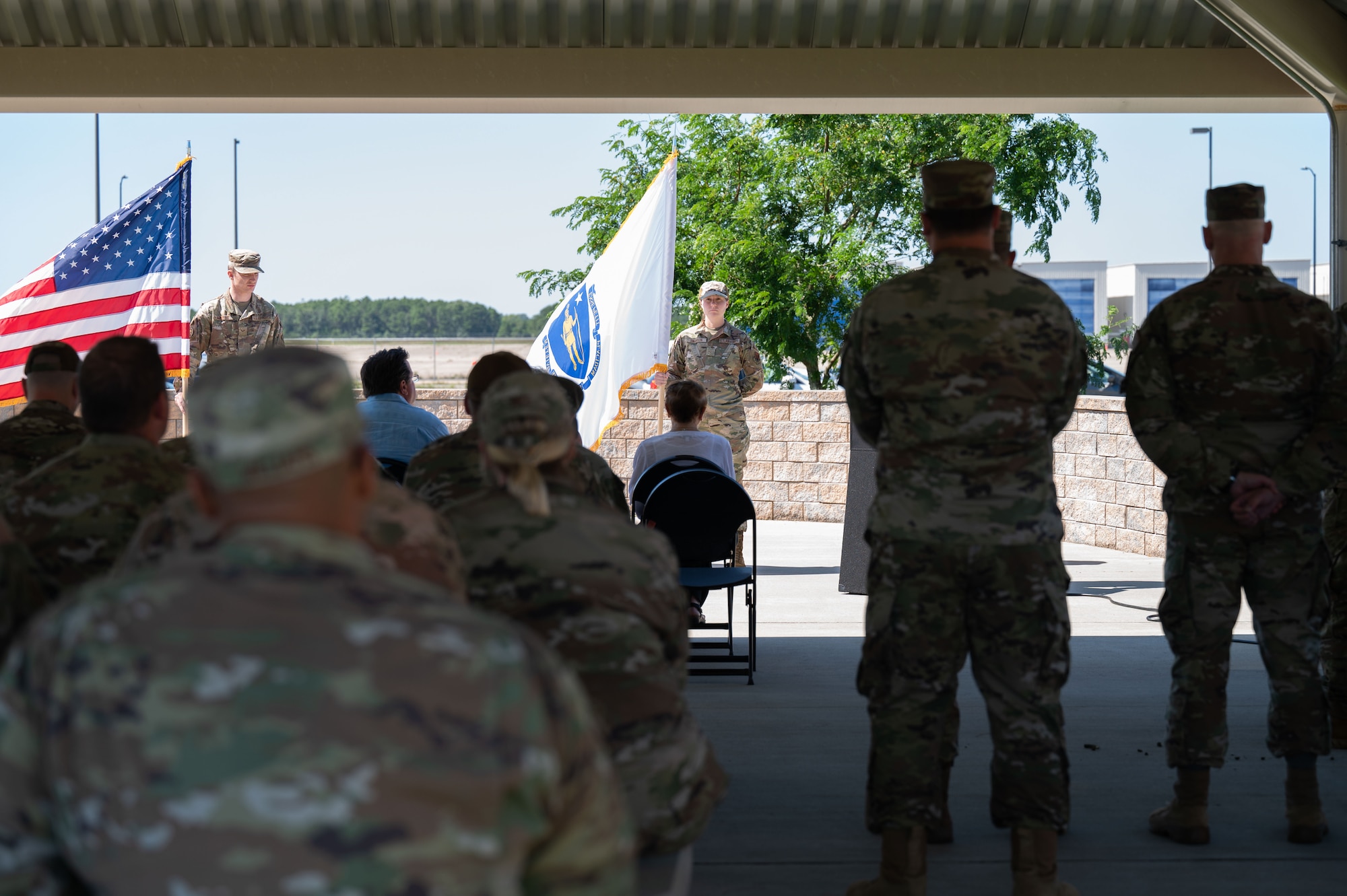 Photo of a ceremony honoring a fallen Airman, his family in attendance.